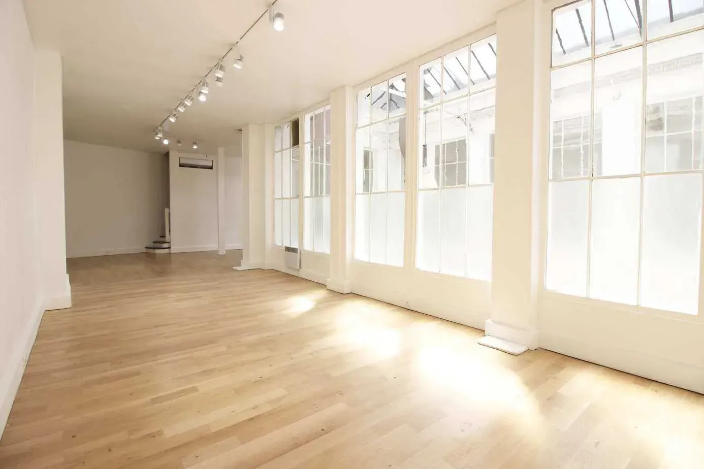 Bright hall with large windows and a light wooden floor