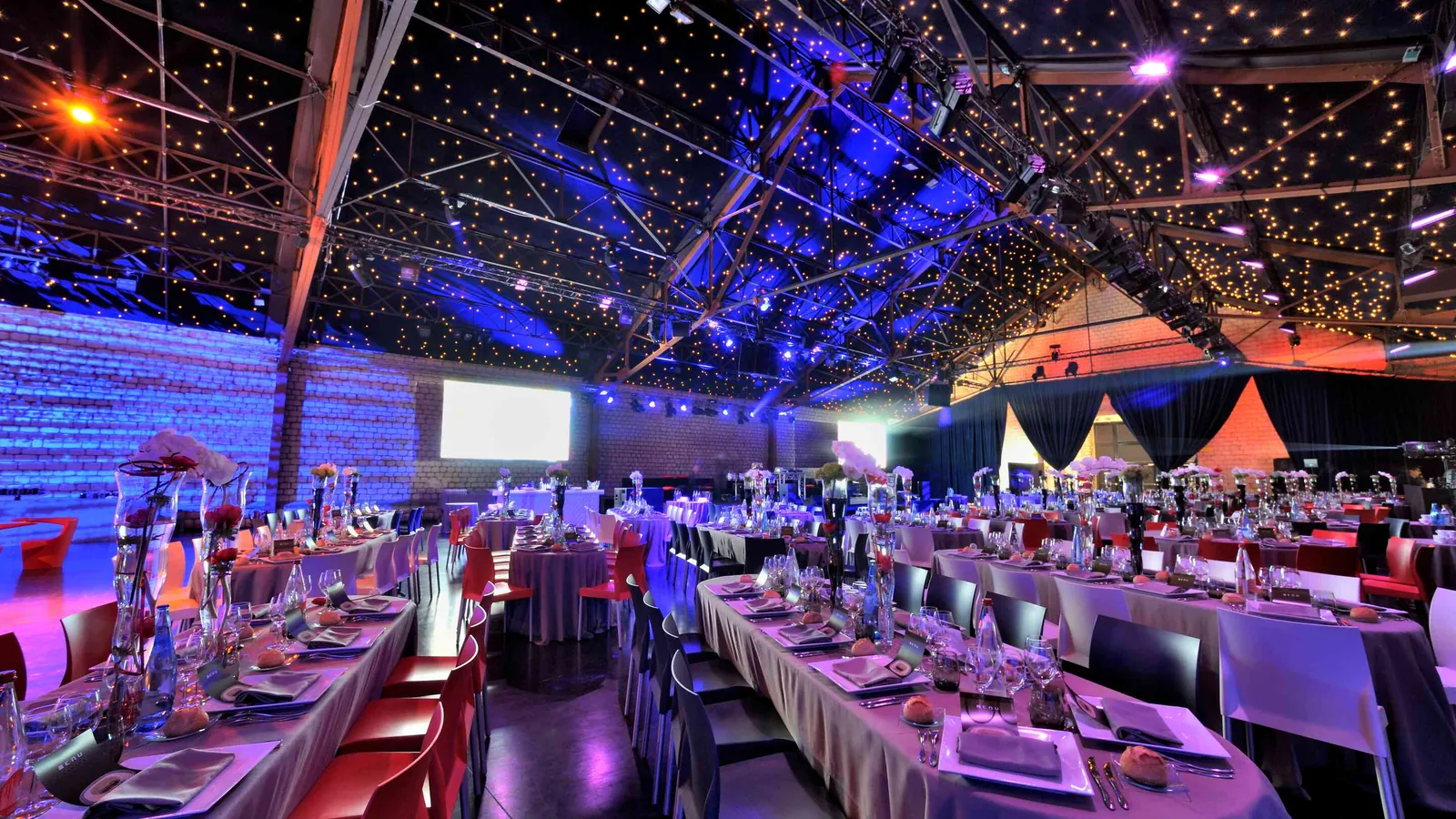 Seine Grand Halls gala dinner with long banquet tables, place settings and a starry ceiling