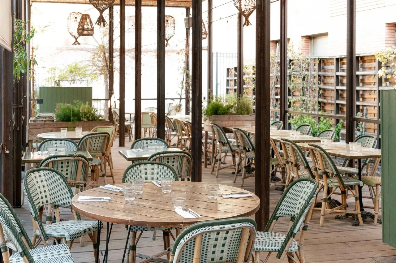 Garden terrace with bistro chairs and climbing plants