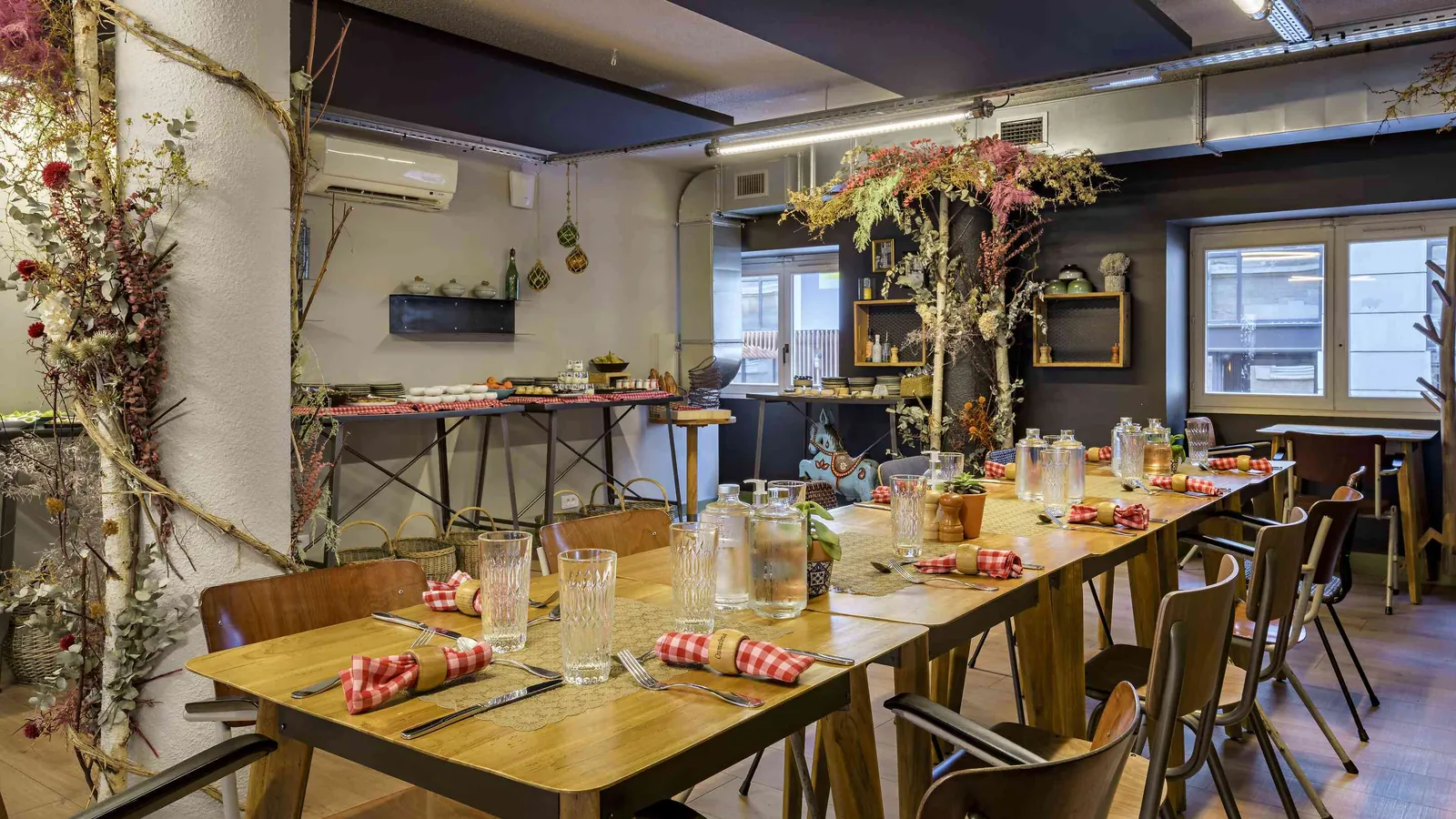 Workshop House dining table set with napkins, cutlery and dried flower arrangements