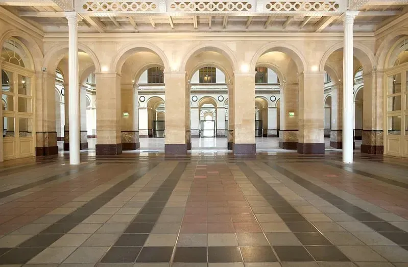 Interior of the neoclassical hall on Place de la Bourse, with columns and high ceilings