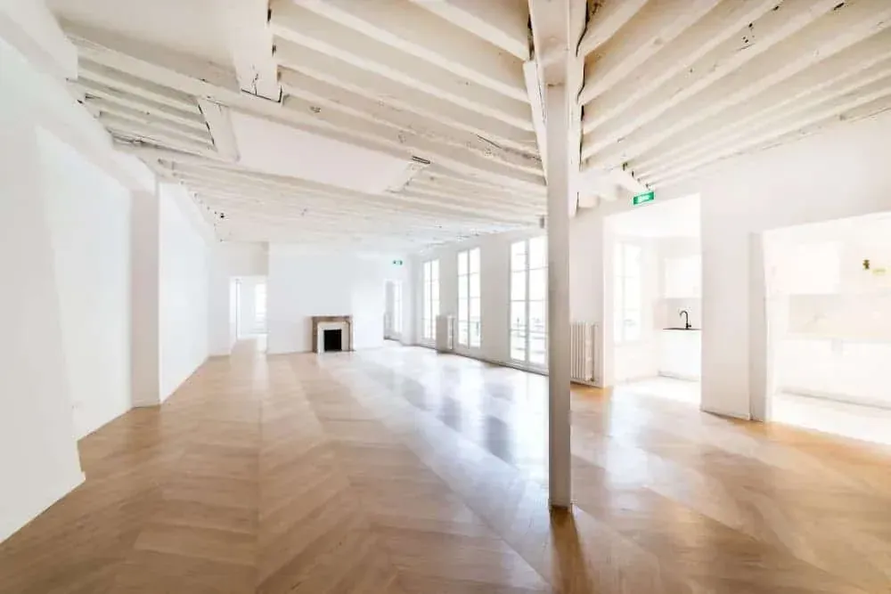 Open-plan loft with exposed beams and hardwood floors