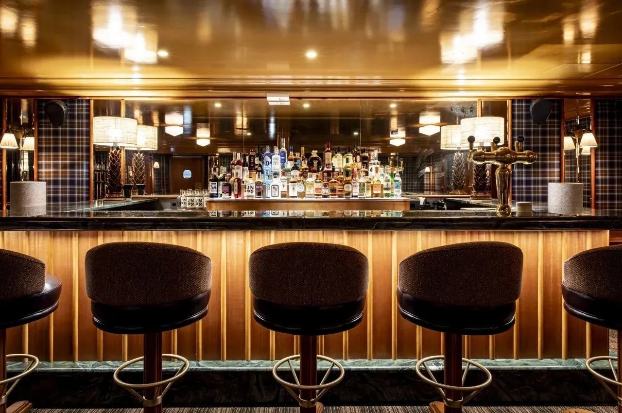 Basement lounge with a bar and wooden panelling