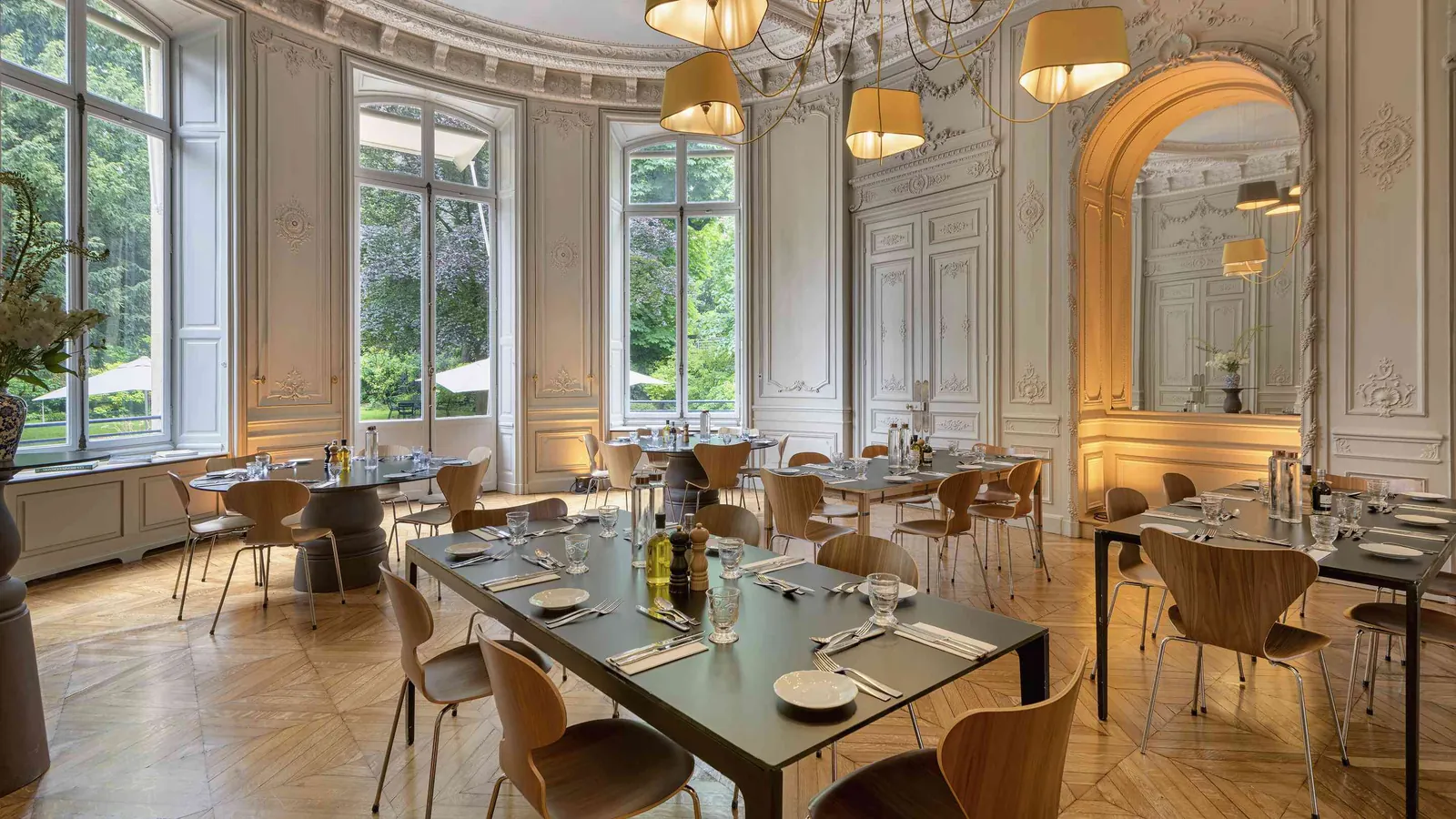 Moulding Salons dining room with a parquet floor, pendant lights and set banquet tables